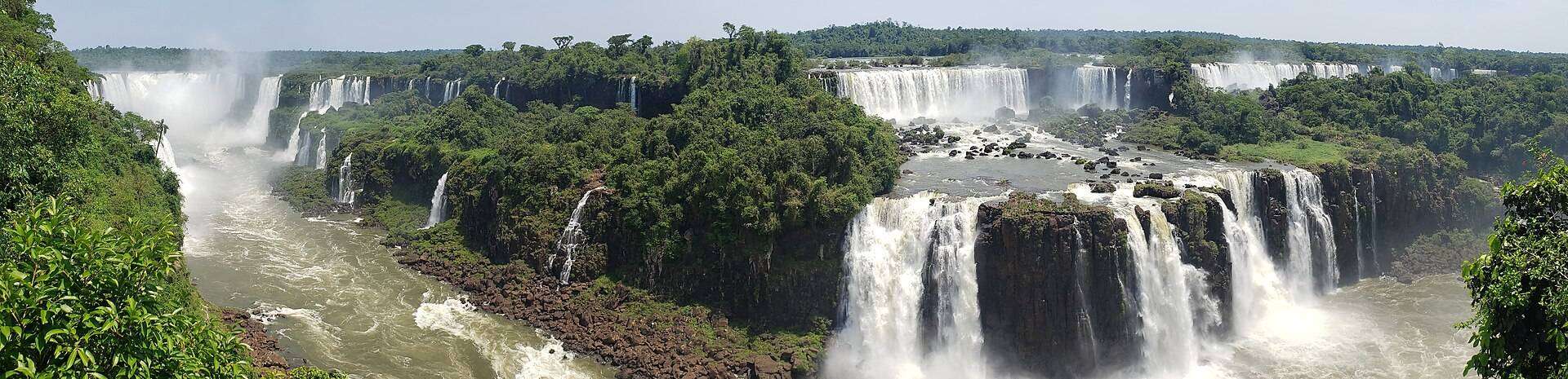 Iguazú Falls pouring around its jungle horseshoe