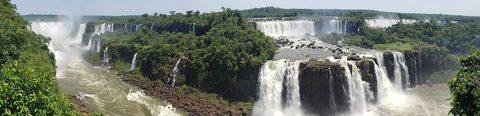 Iguazú Falls pouring around its jungle horseshoe
