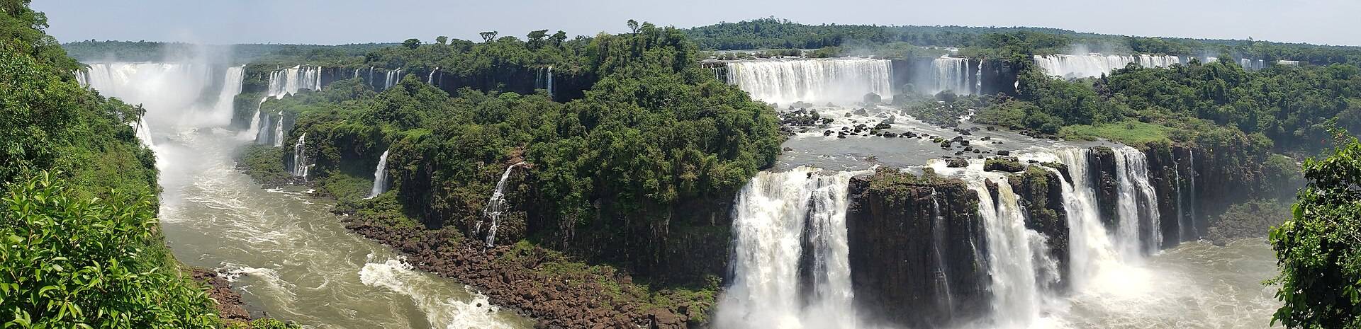 Iguazú Falls pouring around its jungle horseshoe