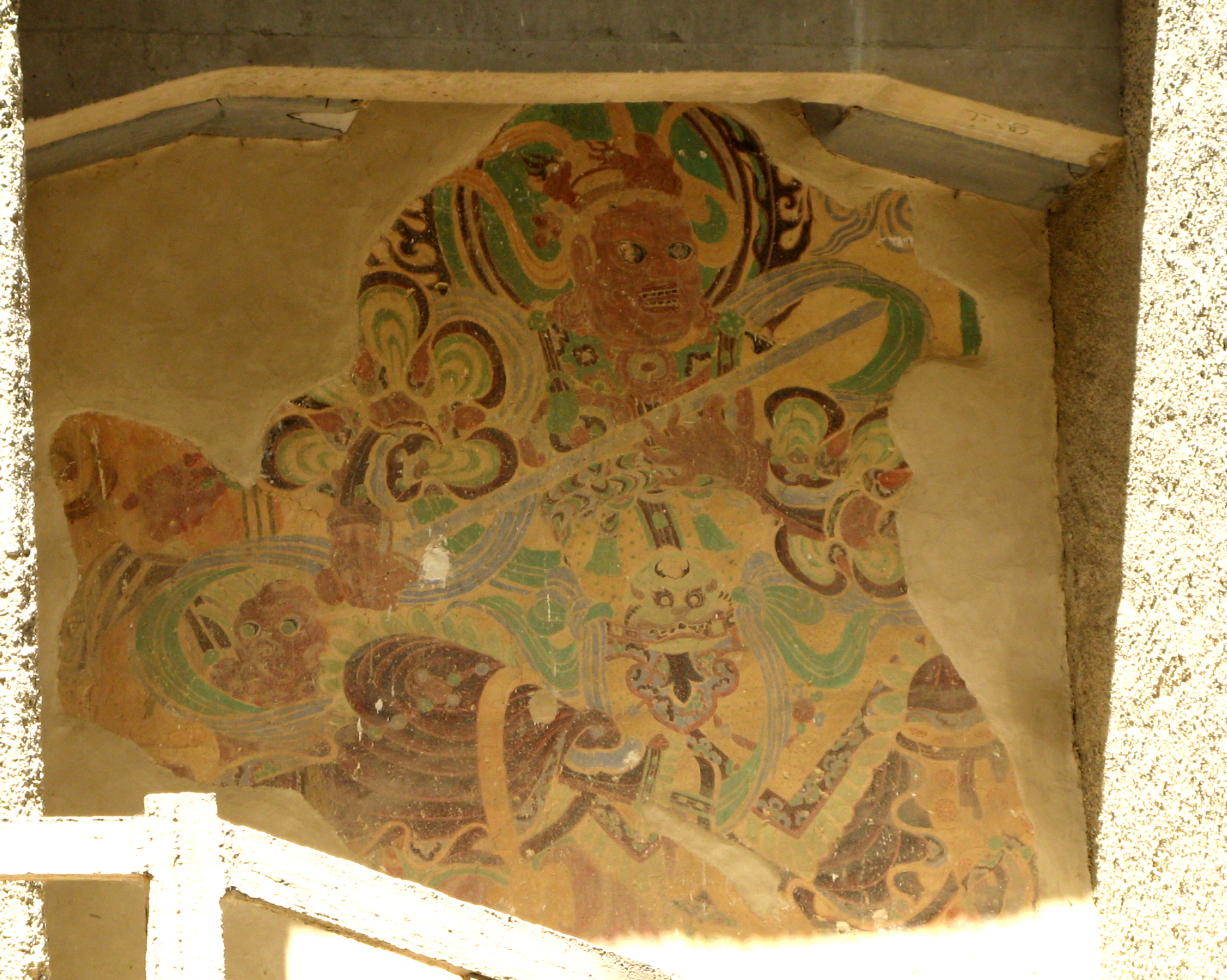 A painted Buddhist figure in a mural at the Mogao Caves in Dunhuang