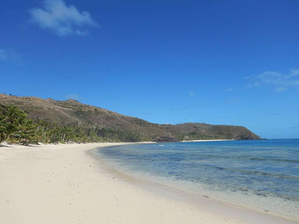 A palm-fringed Fijian island ringed by lagoon