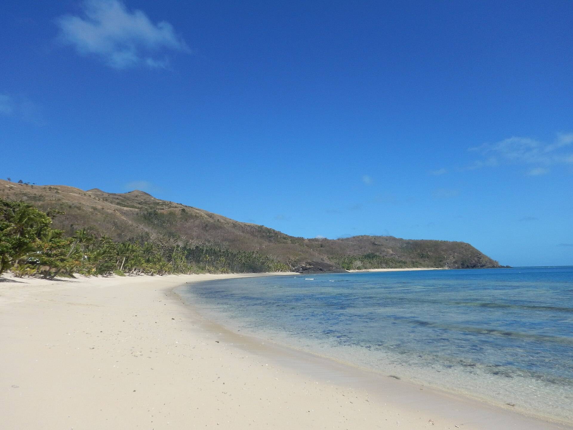 A palm-fringed Fijian island ringed by lagoon