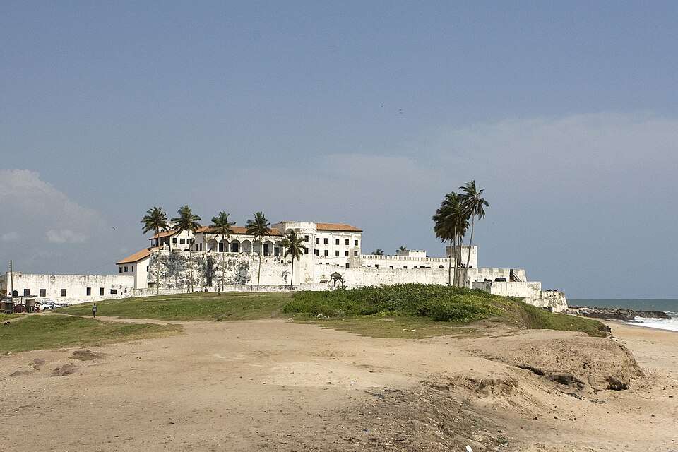 The white ramparts of Cape Coast Castle above the Atlantic surf