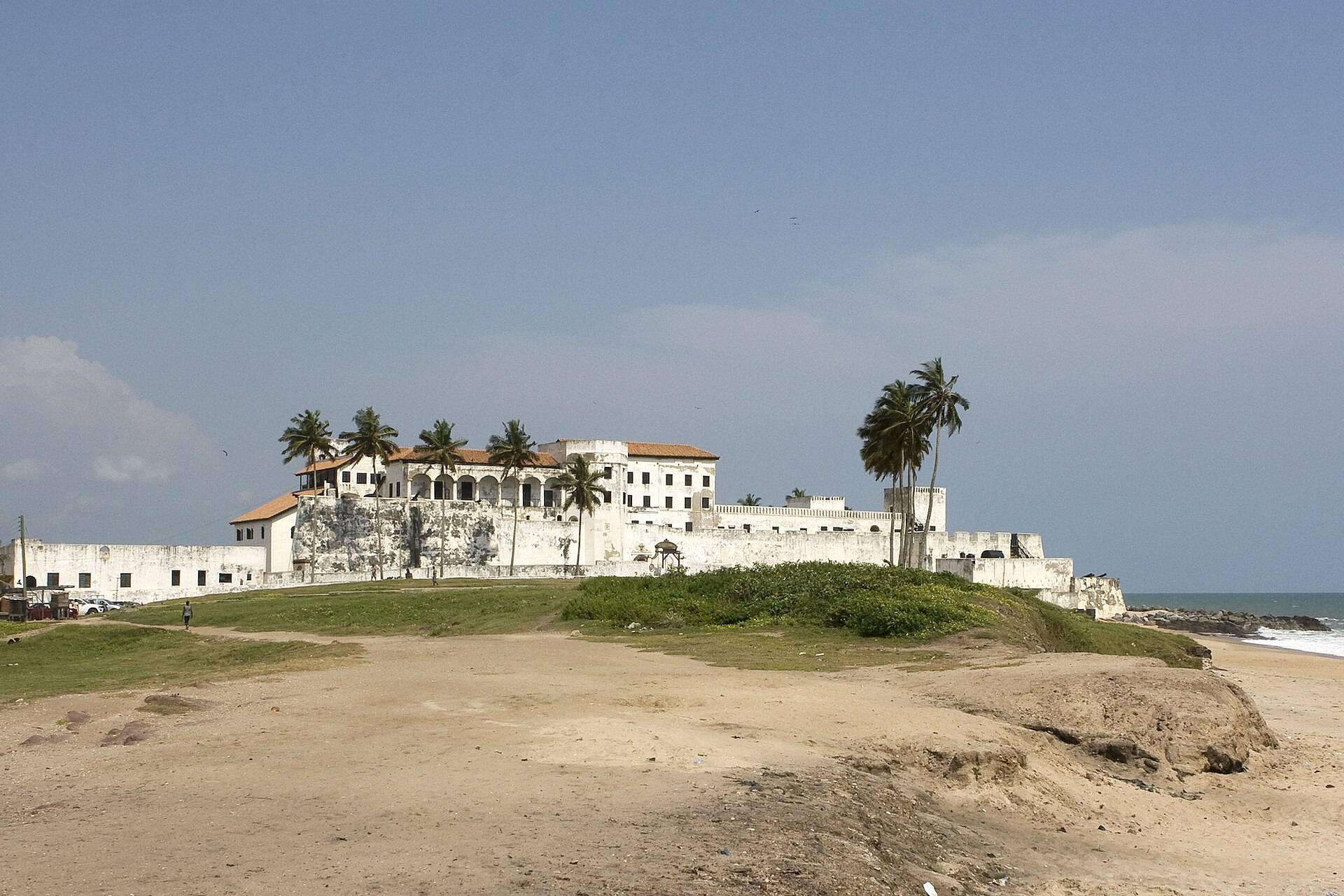 The white ramparts of Cape Coast Castle above the Atlantic surf
