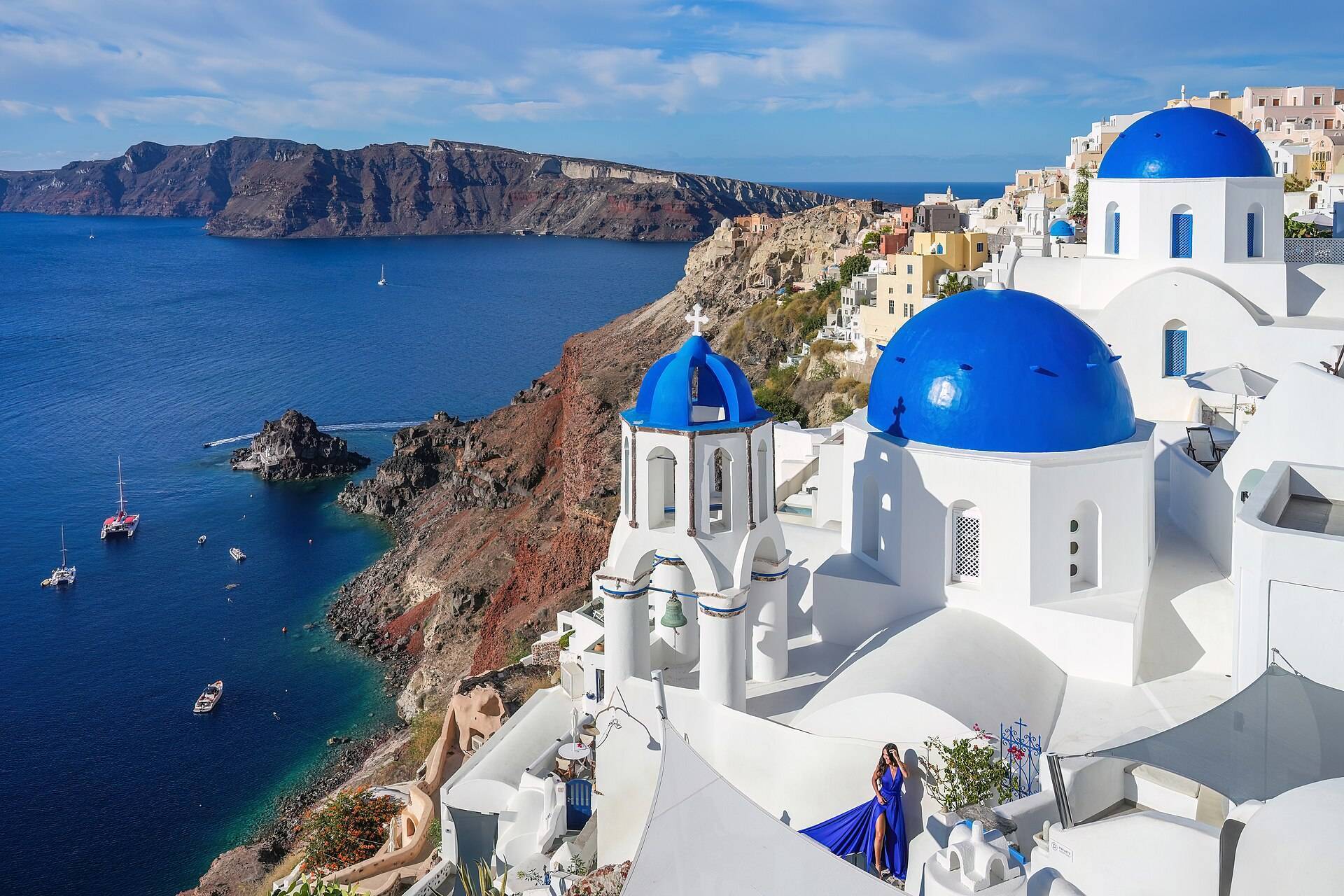 Whitewashed houses and blue domes of Oia above the Santorini caldera