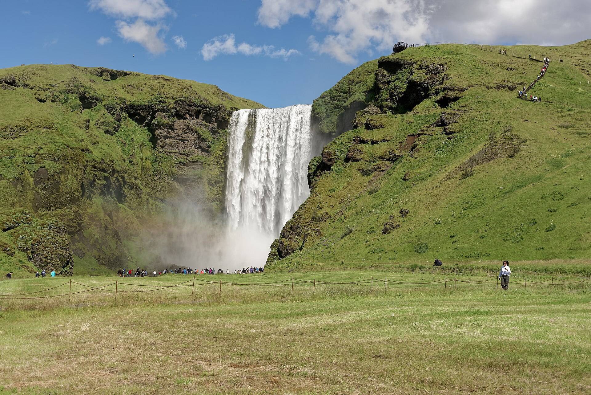 Skógafoss waterfall thundering off the cliffs of Iceland's south coast