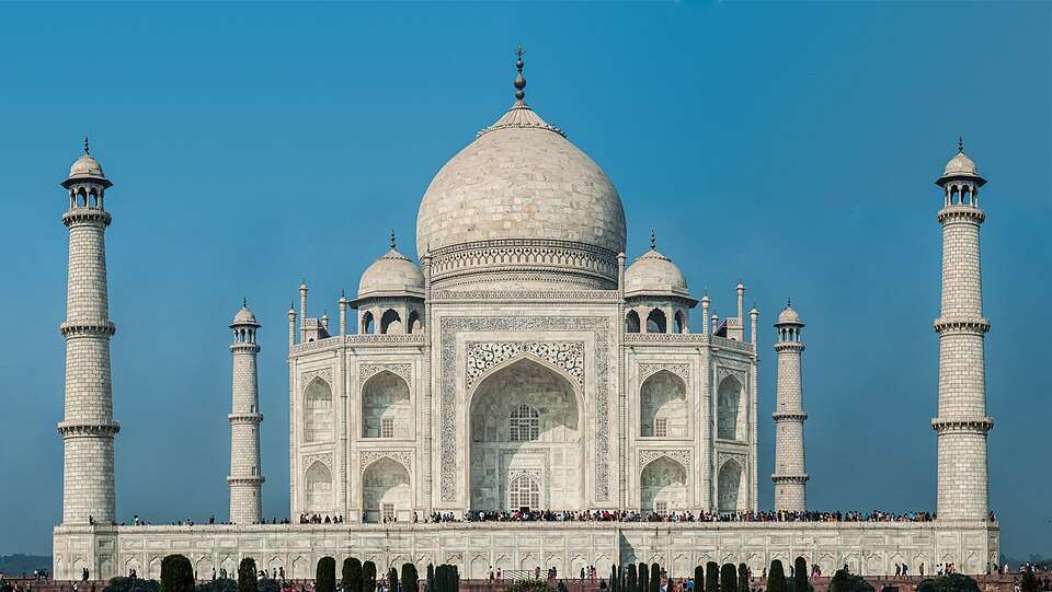The Taj Mahal glowing white above its reflecting pool