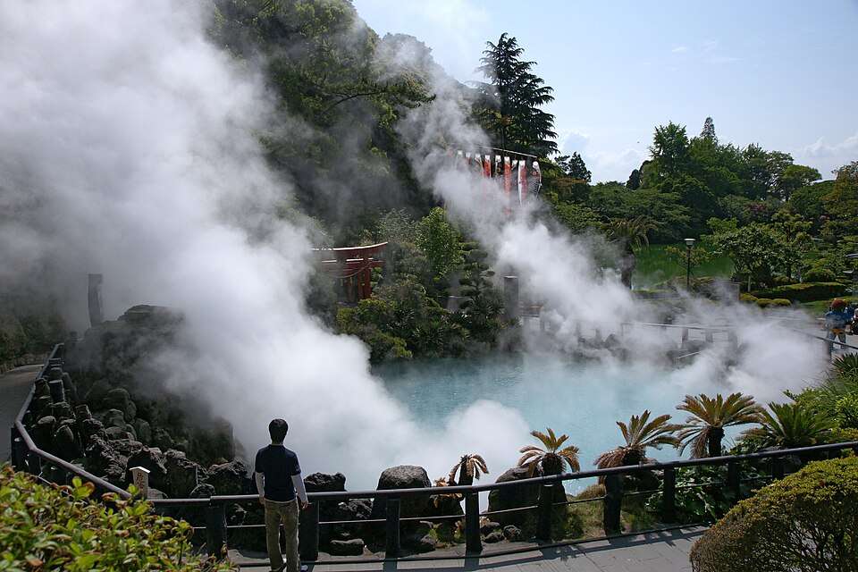 Steam rising across Mount Aso's vast green caldera