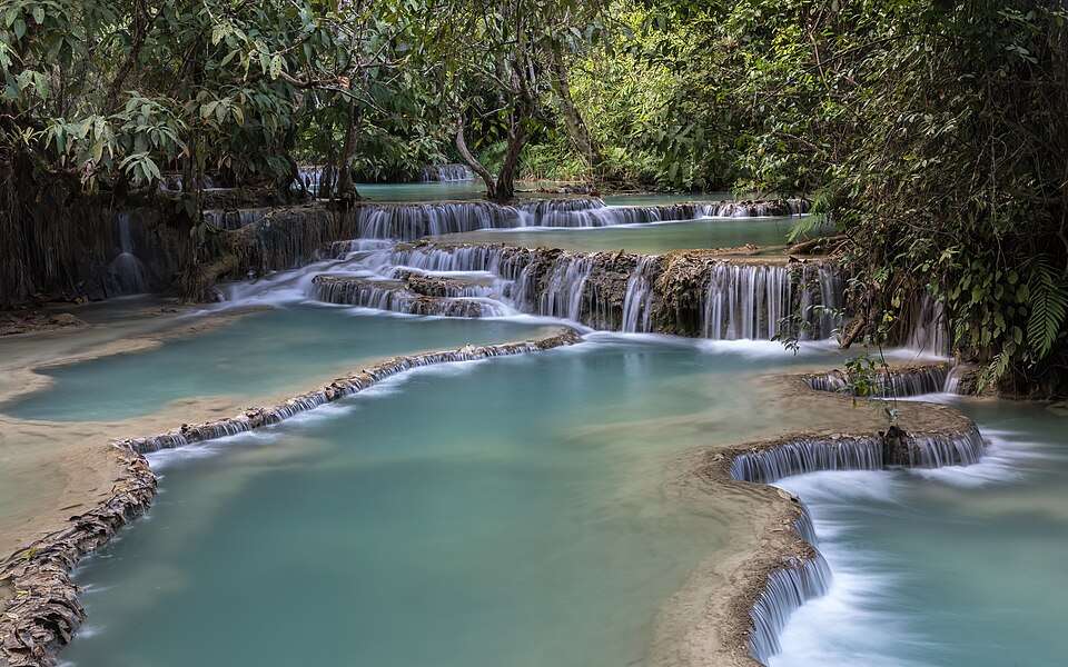 Kuang Si's turquoise pools stepping through the forest