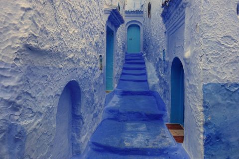 A blue-washed lane climbing through Chefchaouen's medina