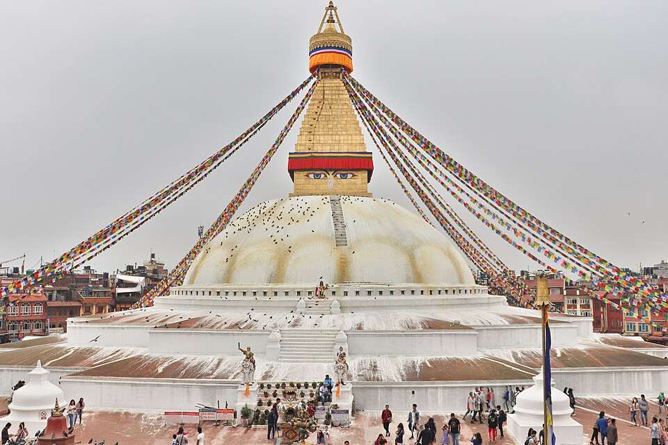 The painted eyes of Boudhanath stupa over prayer flags