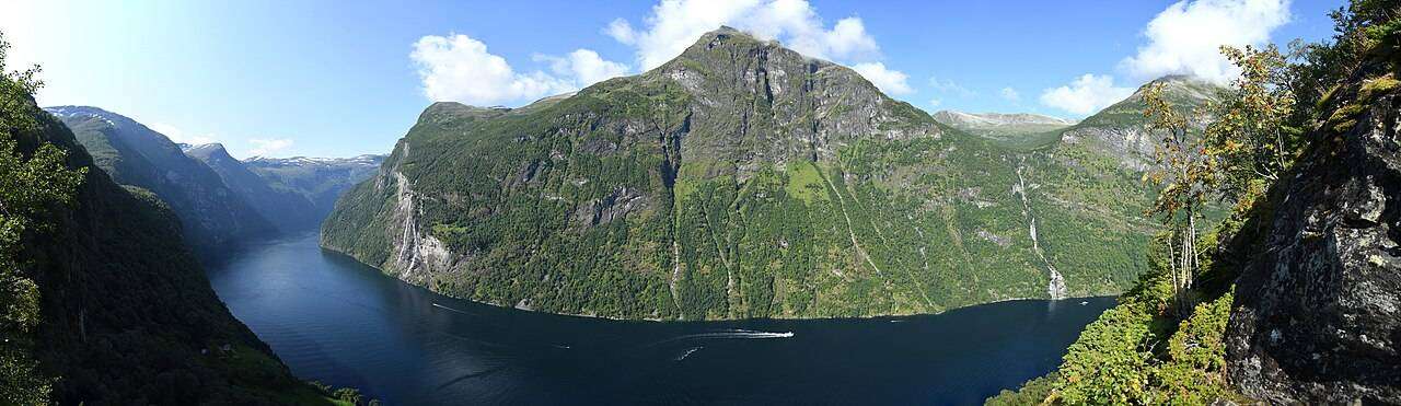 Sheer cliffs and waterfalls dropping into Geirangerfjord