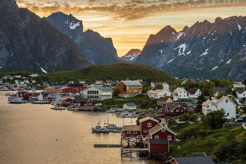 Red rorbu cabins beneath the peaks of Reine in Lofoten