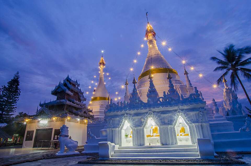 The lit chedis of Wat Phra That Doi Kong Mu above Mae Hong Son at dusk