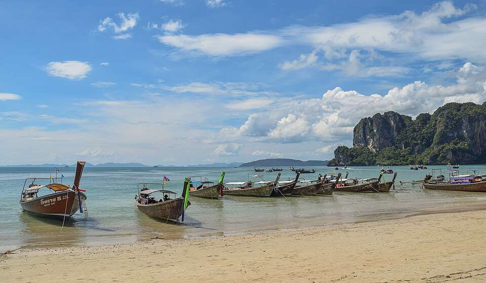 Longtail boats beneath Railay's limestone cliffs